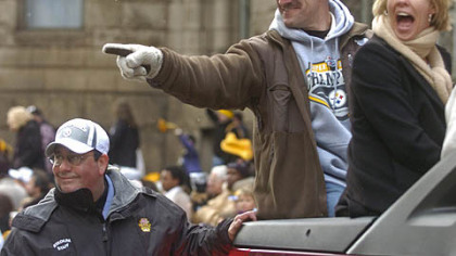 Former Steelers coach Bill Cowher and wife Kaye greet fans during a parade celebrating the team's victory in Super Bowl XL, Feb. 7, 2006.