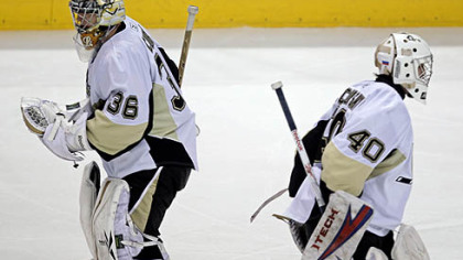 Penguins' John Curry, left, skates off the ice after being pulled from Saturday's game in Vancouver as Alex Pechurski, right comes into the game in relief. Curry allowed five goals on 14 shots.