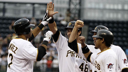 The Pirates' Pedro Alvarez, left, is greeted as he crosses home plate by Garrett Jones (46), Jose Tabata, rear right, and Delwyn Young (24) after hitting a grand slam off Brewers pitcher Dave Bush in the first inning.