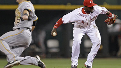 Reds second baseman Brandon Phillips turns to throw the Pirates' Jeff Clement (not shown) out at first base in the seventh inning. The Pirates' Andy LaRoche safely advances to second. Phillips was injured on the play and left the game after the inning.