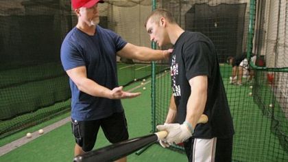 Cardinals hitting coach Mark McGwire, left, works with infielder Brendan Ryan during a training session at a baseball practice facility in Huntington Beach, Calif., Jan. 13.