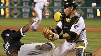 Pirates catcher Ryan Doumit can''t handle the throw from right field as the White Sox's Juan Pierre scores during the ninth inning.