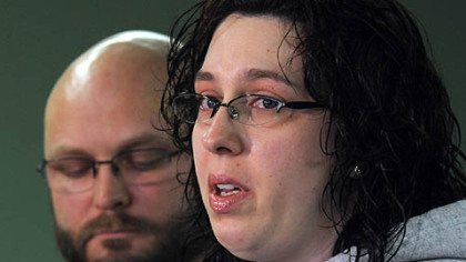 Joy Burkholder, with her husband Lance in the background, talks about her sister, Jennifer Daugherty, whose body was discovered Thursday at Greensburg Salem Middle School.