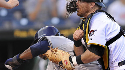 The Brewers' Rickie Weeks runs into Pirates catcher Ryan Doumit at home plate in the first inning Wednesday at PNC Park. Weeks was safe, and Doumit soon would leave the game.