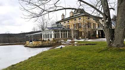 An outside view of the 11,000-square-foot Riverstone Estate mansion with the south pond.
