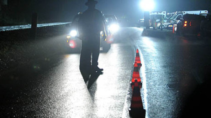 West Virginia State Police officers direct traffic in front of an entrance to the Massey Energy's Upper Big Branch mine in Raleigh County after an explosion there killed at least a dozen people, Monday.