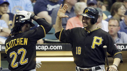 The Pirates' Andrew McCutchen is congratulated by Neil Walker after McCutchen hit a home run during the fifth inning.