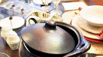A black clay cooking pot joins other ware in a tabletop display at Annex Cookery. The black vessels, straight from tepee-shaped kilns in Colombia, can be used in the oven, on the stovetop, in the microwave and on the table.