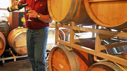 Jim Wilford, owner of Fletcher Bay winery on Bainbridge Island, pours a glass of red wine. He makes his wines using grapes from Columbia Valley, Walla Walla and the Yakima Valley.