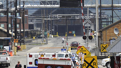 Emergency personnel enter the U.S. Steel's Clairton coke plant near the site of an explosion in B battery coke-making operation.