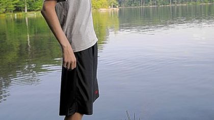 Patrick Duggan, 14, of Troop 301 in Robinson, shows off a bass he caught July 7 in Lake Courage at Heritage Reservation.