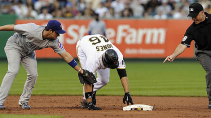 The Pirates' Garrett Jones gets into second base safely as he's tagged by Cubs shortstop Ryan Theriot in the third inning.