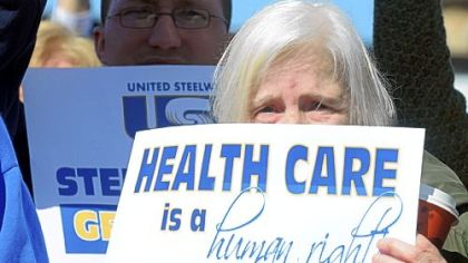 Georgeanne Koehler, 63, of Bloomfield, and other supporters of health care reform rally Tuesday outside U.S. Rep. Jason Altmire's office in Aliquippa.