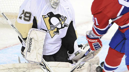 Penguins goaltender Marc-Andre Fleury makes a save on Canadiens forward Scott Gomez during Tuesday's game at the Bell Centre in Montreal.