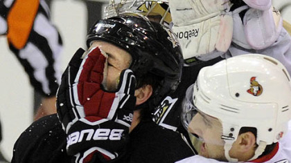Senators forward Nick Foligno gets his glove in the face of Penguins defenseman Brooks Orpik in the second overtime Thursday's game at Mellon Arena.