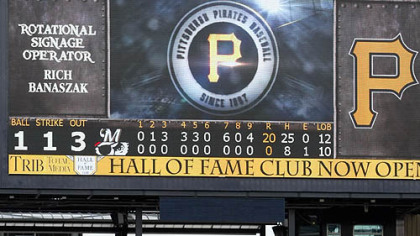 The scoreboard shows the historic final tally as the Brewers go through their post-victory line Thursday at PNC Park.
