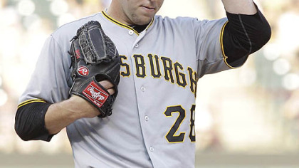 Pirates starting pitcher Paul Maholm removes his cap after giving up a home run to the Rangers' Michael Young during the first inning.