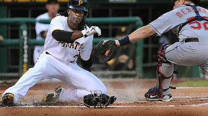 Andrew McCutchen slides past Cleveland catcher Mike Raymond to score in the third inning Saturday at PNC Park.