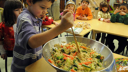 Kindergartner Asher King works on a stir-fry at the Kentucky Avenue School in Shadyside last week.
