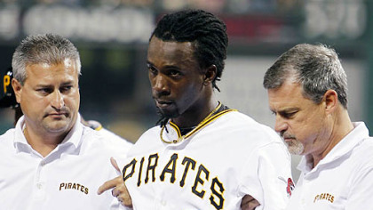 The Pirates' Andrew McCutchen is helped off the field by trainers Brad Henderson, right, and Mike Sandoval, left, during the second inning.