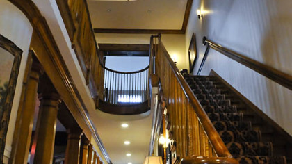 The first floor opens to a grand entry hall and its tiger-wood maple staircase that is open to all three floors. The spiral staircase leads to a fourth-floor widow's walk and cupola.