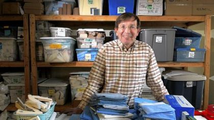 Dr. Jack Demos, founder of Surgicorps International, with supplies that will be shipped overseas.