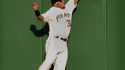 Pirates center fielder Jose Tabata climbs the wall but can not make a catch on ball hit by the Brewers Rickie Weeks.