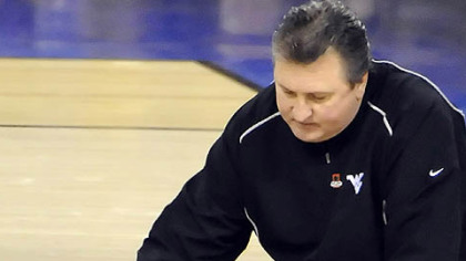 West Virginia coach Bob Huggins comforts Da'Sean Butler after Butler injuredhis leg against Duke in the second half of the semifinal game in the NCAA tournament in Indianapolis Saturday.