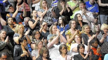 Mourners applaud during Sunday's service.