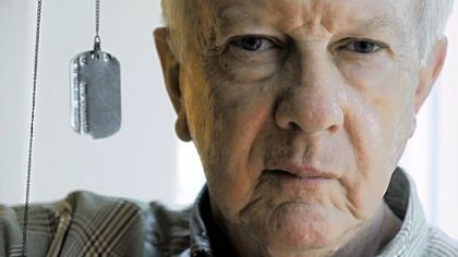 Walter Reuter III, 75, of Edgeworth, holds his father's dog tag, which was found on a World War II battlefield in Germany.