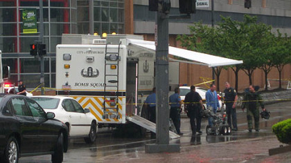 The Pittsburgh police bomb squad unloads its robot to inspect the contents of a microwave oven that was found near the finish line.