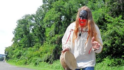 Eugene Strong, director of the Mound Society of Western Pennsylvania, sings and drums at the Indian burial mound in McKees Rocks, the largest such mound found in the state. His face is painted in Pottawatomi colors in honor and respect for the dead. The mound was partially excavated in 1896, but Mr. Strong and his group believe that bones of the Adena Indians still remain there.