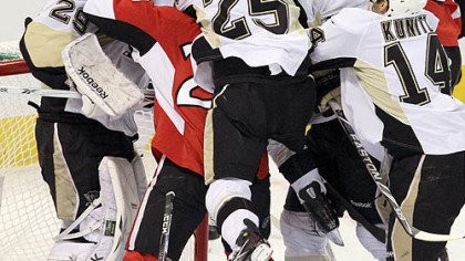 Max Talbot jumps on Ottawa's Chris Neil in a scrum in front of Marc-Andre Fleury in the first period Tuesday night in Game 4 in Ottawa.