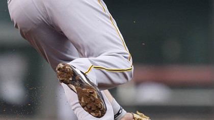 Pirates third baseman Neil Walker fields a ground ball, then whirls to retire the Reds' Brandon Phillips in the third inning.