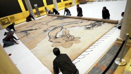 Ellen Baxter, chief conservator at the Carnegie Museum of Art, inspects Salvador Dali's 1942 stage curtain "Theseus Minotaur," which he painted for the Ballet Russe de Monte Carlo, after it was unrolled in the Hall of Sculpture for the first time in late December.