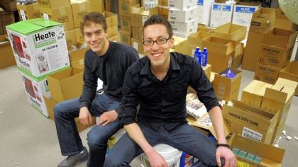 Brett Satterfield, right, Web master of Rollier's Hardware's online site, sits with his brother, Derek, in a former conference room that has been turned into a packing center at the store in Mt. Lebanon.