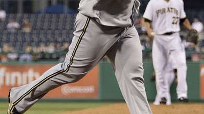 Pirates pitcher Jeff Karstens stands on the mound as the Brewers' Prince Fielder trots home after hitting a solo home run in the fifth inning.