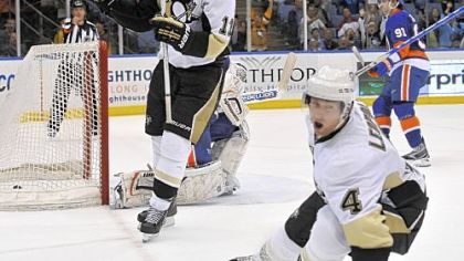 Jordan Staal, left, and Jordan Leopold celebrate Leopold's overtime goal against the Islanders Sunday.