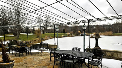 The conservatory opens to a stone terrace that overlooks the south swan pond. The patio was built from sandstone obtained when excavating the south pond.