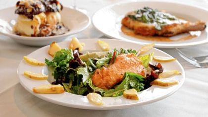 Gary Komoroski's dishes at Scoglio's in Green Tree include warm pear salad with salmon and gorgonzola cheese, front; homemade profiteroles with vanilla ice cream, toasted almonds and chocolate fudge sauce, left; and a pork chop with panko crumbs with fresh spinach, Bel Paese cheese and lemon white wine with veal stock.