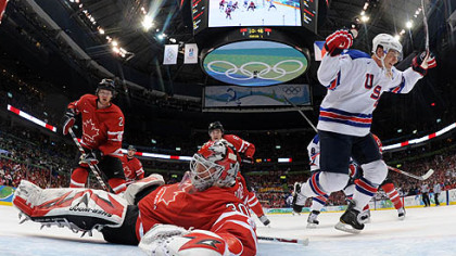Jamie Langenbrunner celebrates one of U.S. teammate Brian Rafalski's goals against Canada's Martin Brodeur.