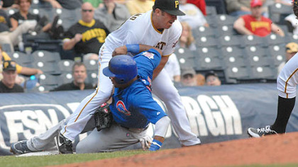 The Cubs' Marlon Byrd slides hard into third base, where Pirates starter Dana Eveland was covering during a rundown in the third inning. Some dirt got into Eveland's eye and, coincidence or not, Eveland later hit Byrd with a pitch.