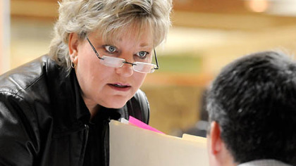 Suzanne Chichester of McDonald interviews at the tables set up by firms seeking workers at the job fair held at The Mall at Robinson on Thursday. Ms. Chichester lost her job a year ago and is nearing the end of her unemployment benefits.