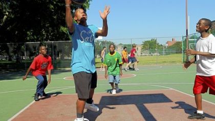 Staying active on the basketball court in Allegheny Commons Park, North Side, is Paul Currington, 16, a Perry High School student going up for a basket; and, from left, Christopher Shannon, 11, Malik Russell, 12, and D.J. Williams.