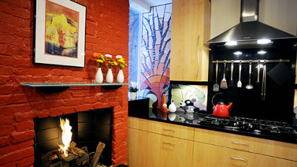 A bright-red fireplace is the kitchen's focal point.