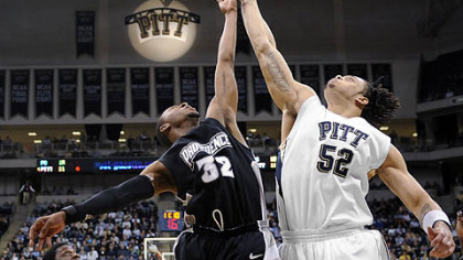 Pitt's Gary McGhee and Providence's Vincent Council go for a rebound in the first half.