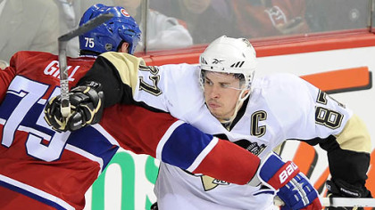 Penguins forward Sidney Crosby battles with Canadiens defenseman Hal Gill during Tuesday's Game 3 in the Bell Centre in Montreal.