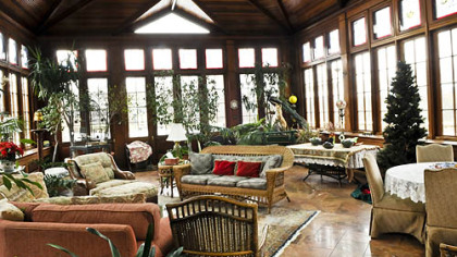 Sliding pocket doors with leaded glass windows lead to a conservatory designed and installed by Tanglewood Conservatories of Denton, Md. Mahogany was used to frame the windows, ceiling and skylights.