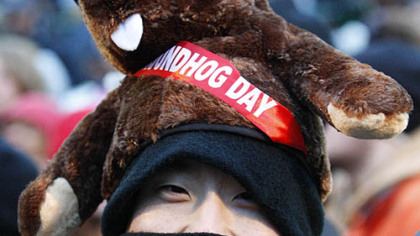 Charles Lim, of New York City, braves the weather on Gobbler's Knob to watch Punxsutawney Phil.