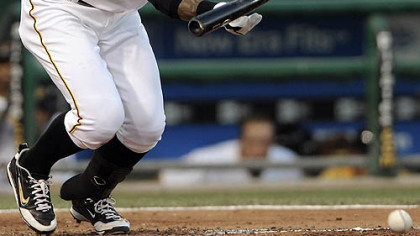 The Pirates' Ronny Cedeno lays down a bunt to bring in Pedro Alvarez in the fourth inning.